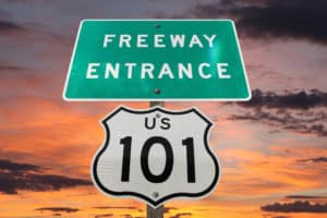 US 101 freeway entrance sign with sunset